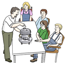 Ein Mann erklärt vier Schülern eine Maschine Ein Mann erklärt vier Schülern eine Maschine